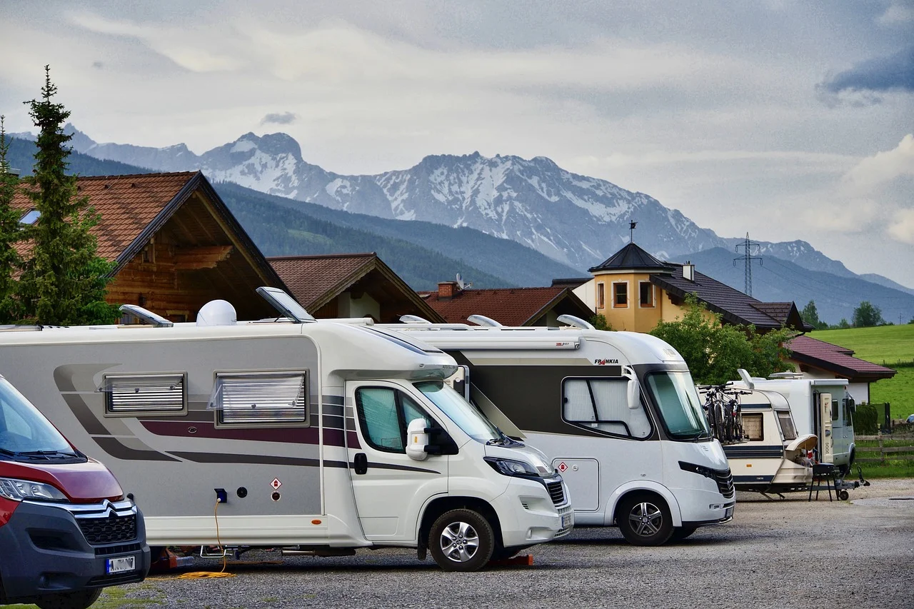 rv, trailer parked in a lot.